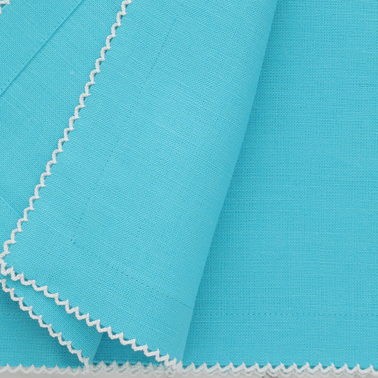 Close-up of aqua napkin with white picot trim