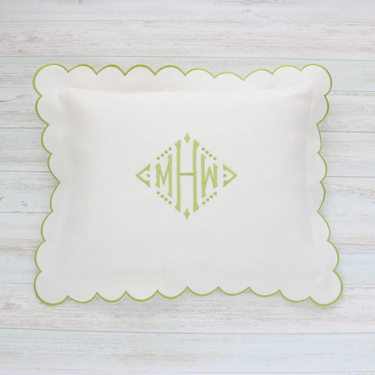 White pillow with green scalloped edge and monogram MHW in sage green handmade by Cora's Linen