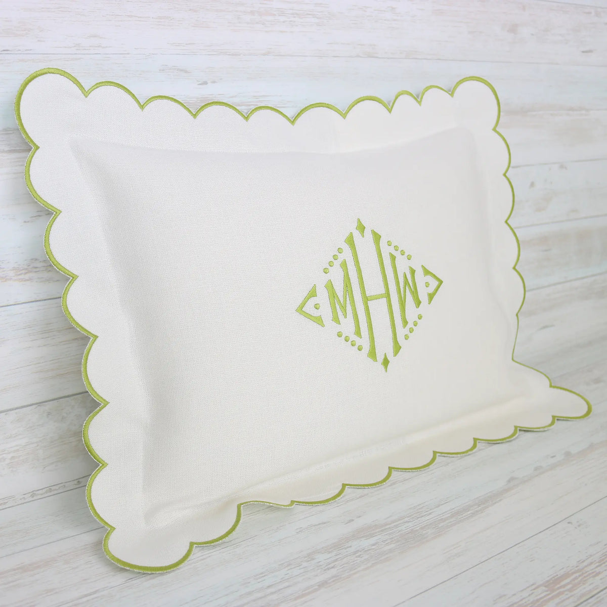 White pillow with green scalloped edge and monogram MHW in sage green handmade by Cora's Linen