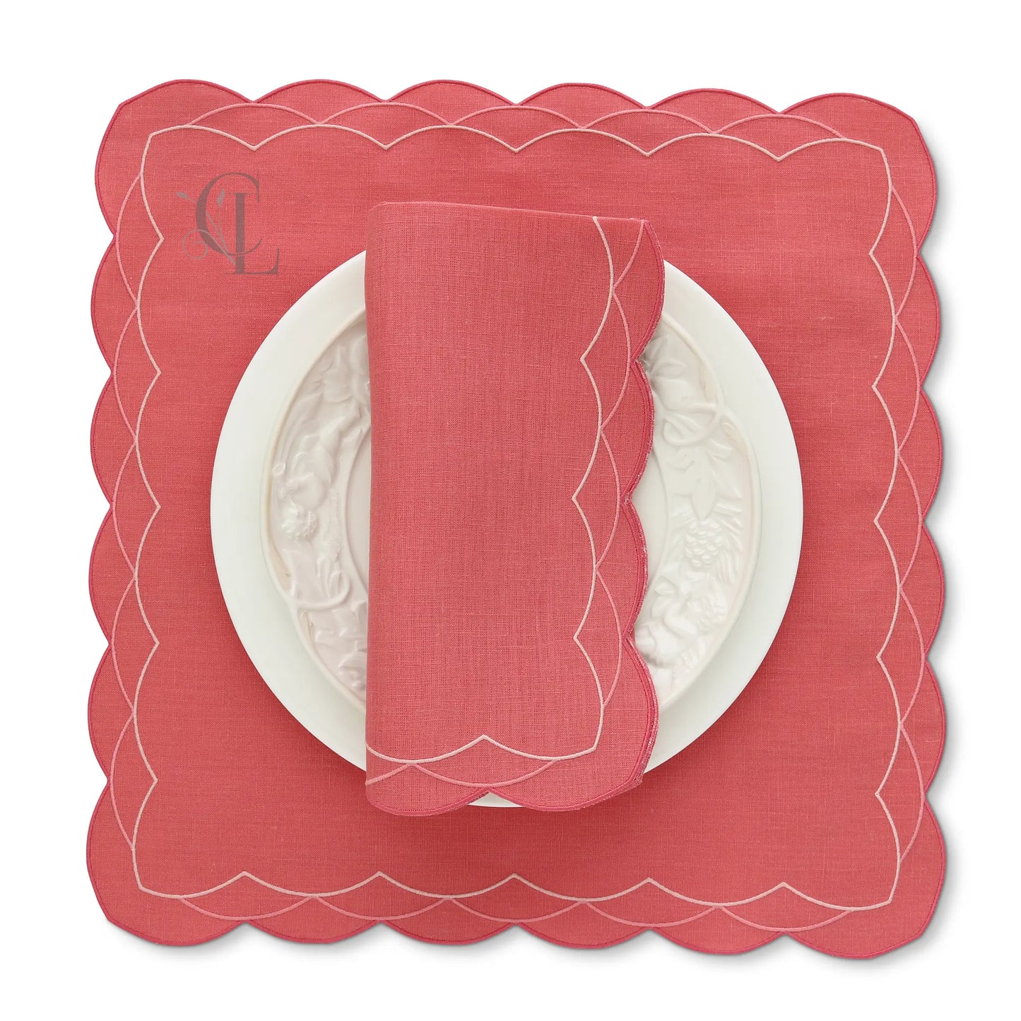 Lobster Red scalloped Cosmo placemat with a matching napkin on a white background