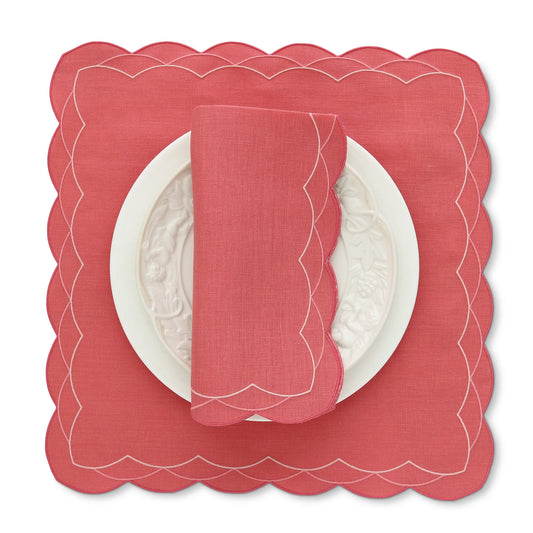 Lobster Red scalloped Cosmo placemat with a matching napkin on a white background