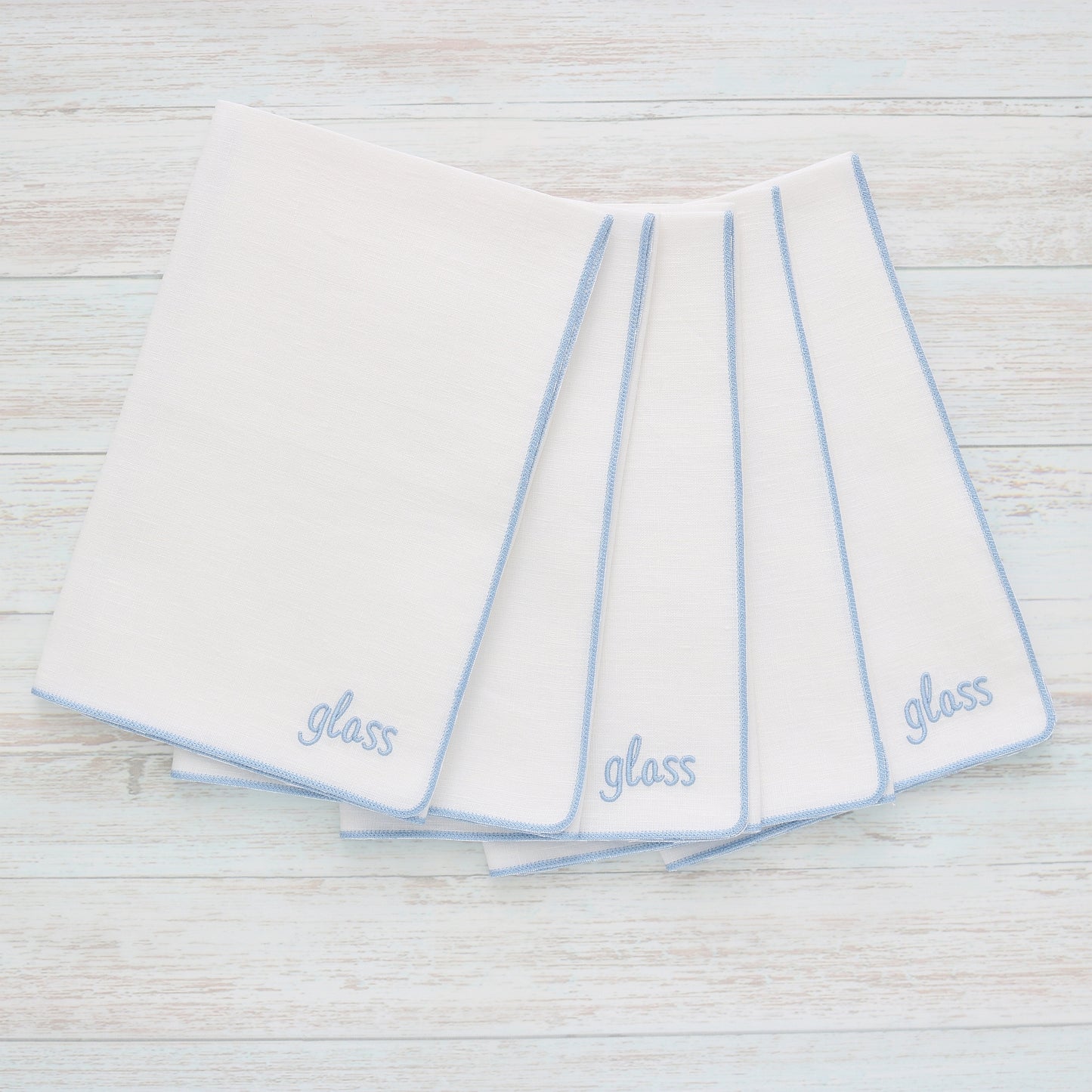White linen polishing kitchen towel, in style "Merrow" with Baby Blue trim, set of five, with word "glass" stitched on the bottom corner, handmade by Cora's Linen