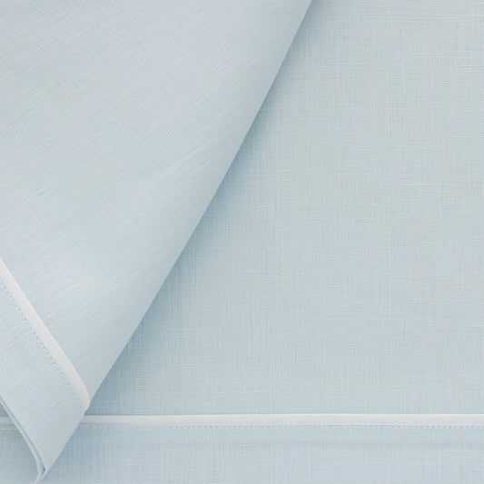 closeup of baby blue napkins with white inset tape