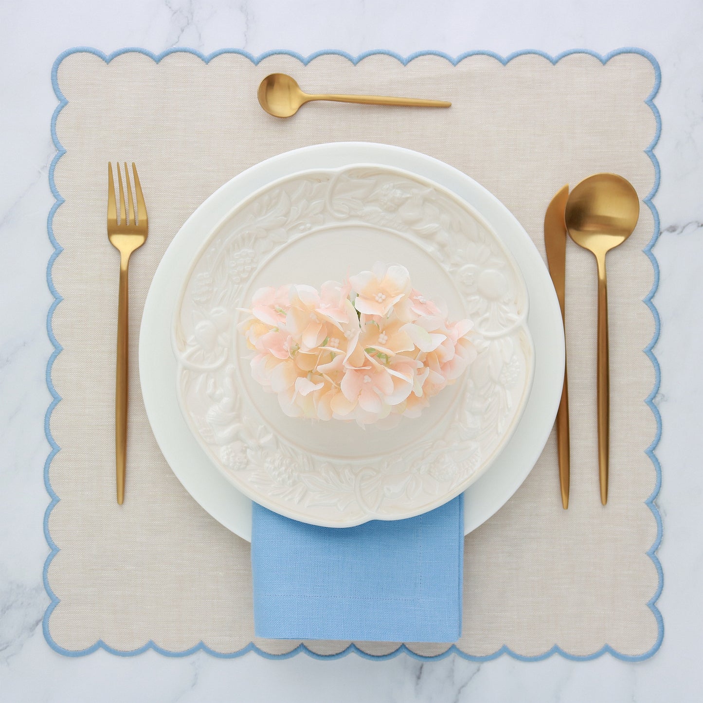 Place setting with Beach scalloped placemat and cool blue dinner napkin