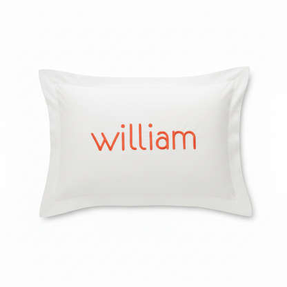 A white rectangular pillow sham featuring the name 'william' printed in orange lowercase letters across the center, shown against a plain white background.