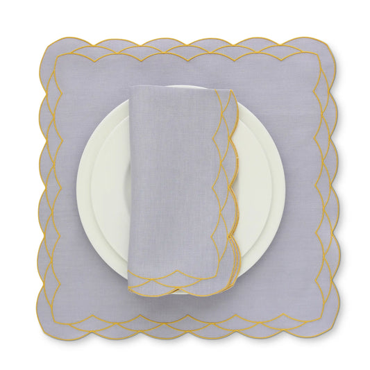 Decorative scalloped Cosmo Lavanda Rosa napkin and placemat with Yellow trim