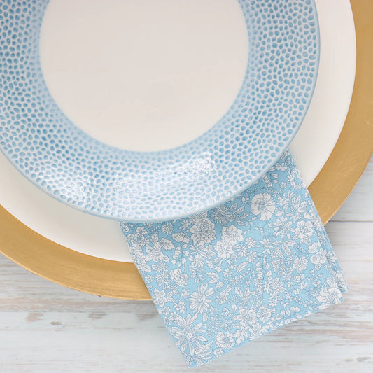 Liberty London Emily Belle Blue Sky dinner napkin by Cora's Linen under a blue plate