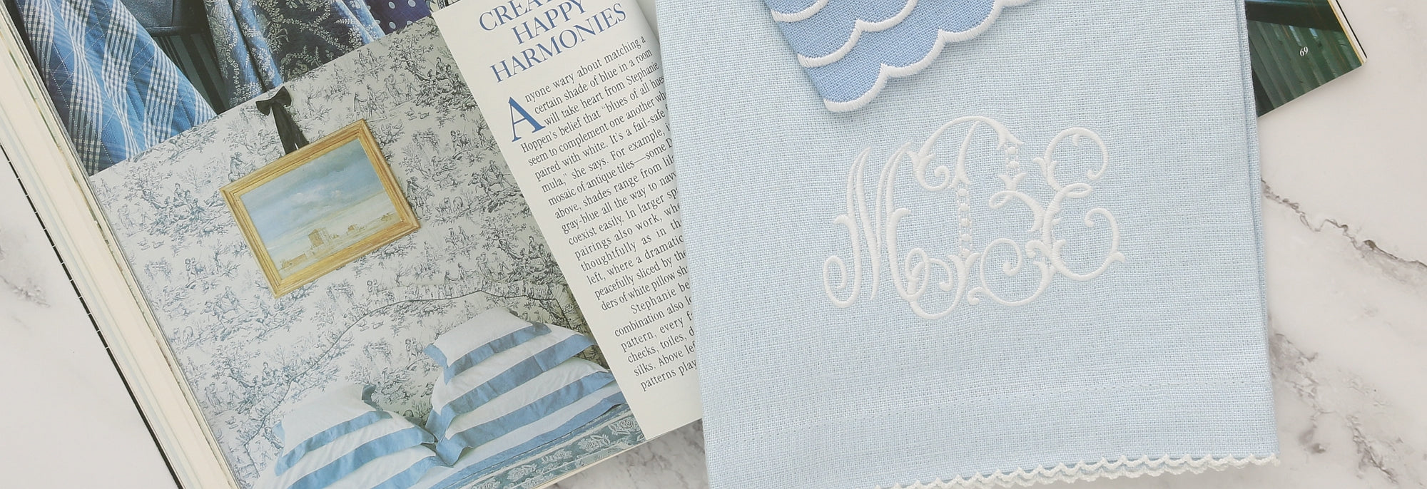 monogrammed blue guest towels placed on an open Victoria magazine initials MBE