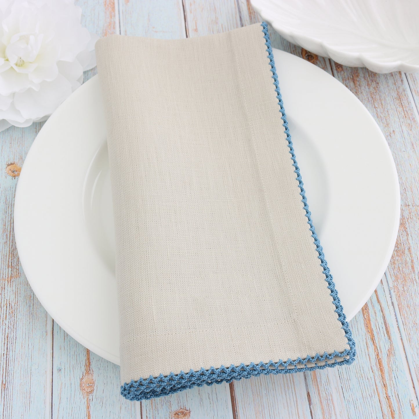 place setting with Sand linen napkin and Paradise Blue picot trim