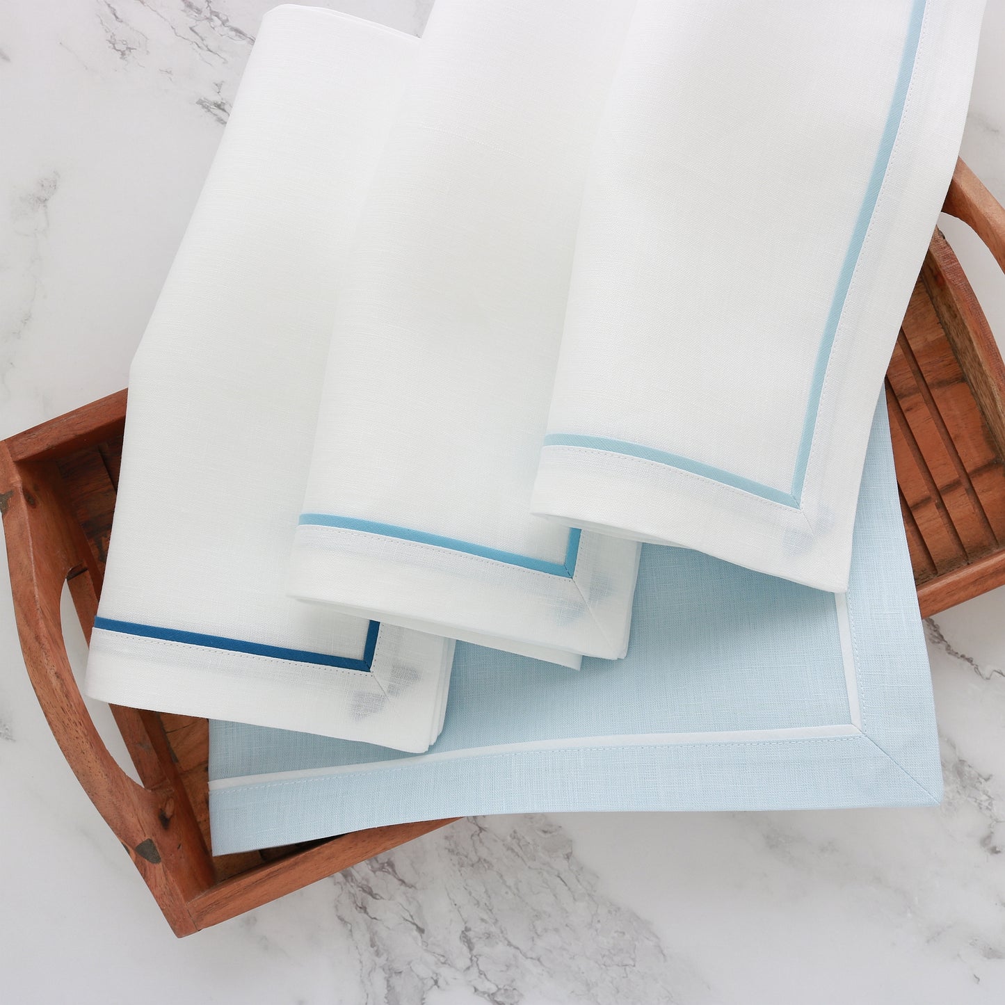 various white napkins with blue inset tape