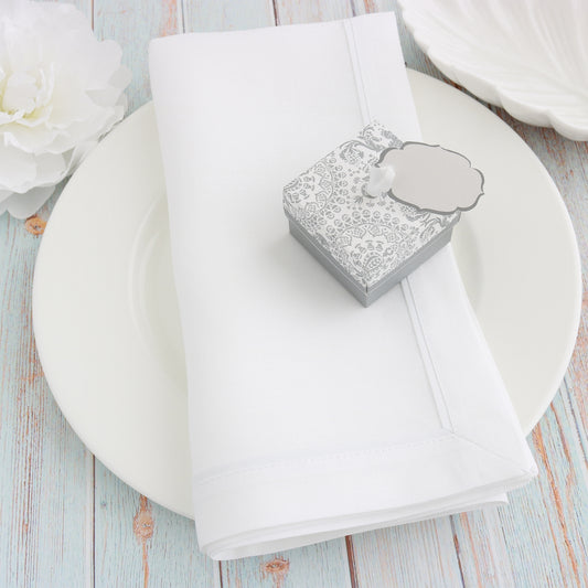 white napkins with white inset tape