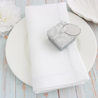 white napkins with white inset tape