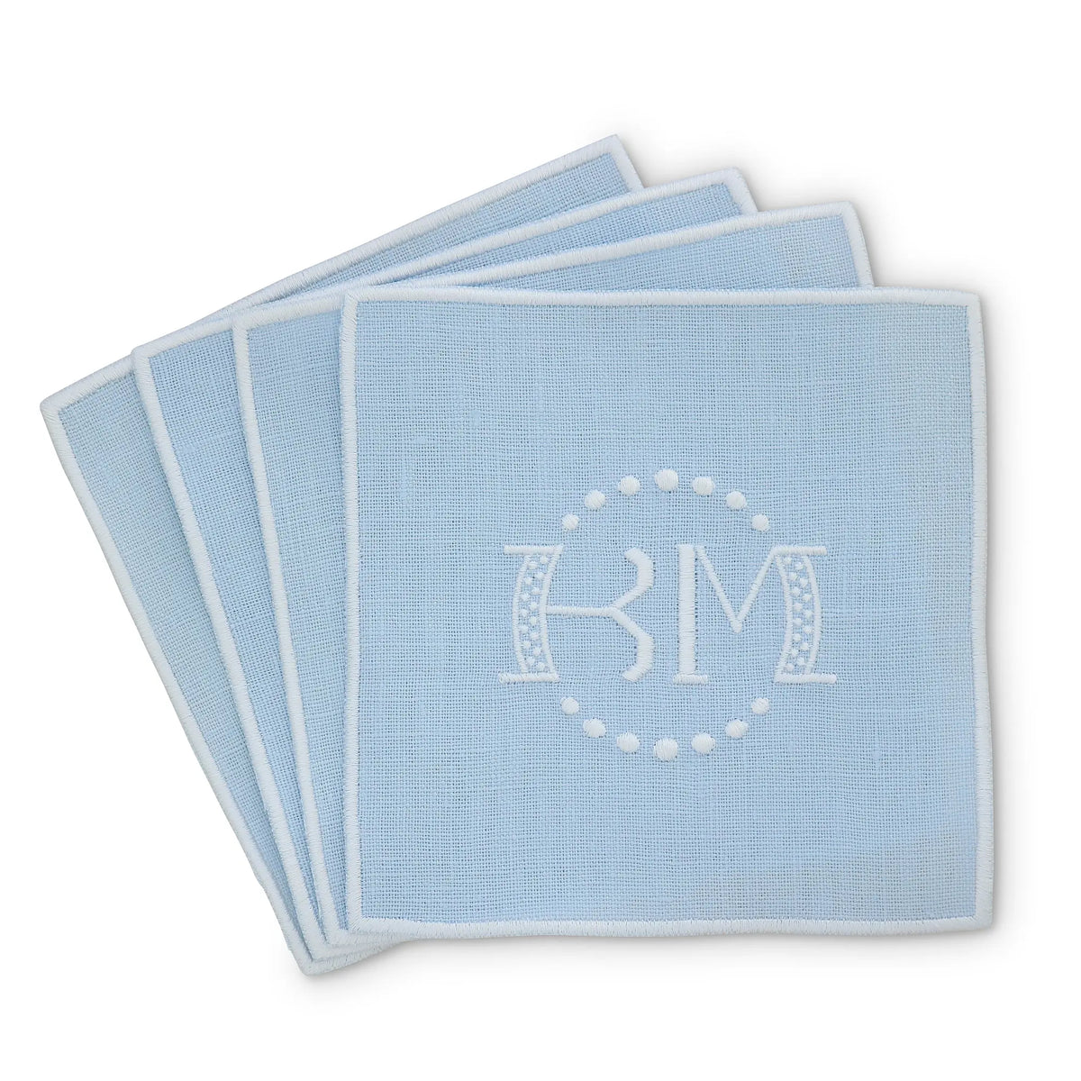 baby blue straight edge Turin cocktail napkin set of 4, arranged in an overlapping fan pattern with monogram KM, handmade by Cora's Linen
