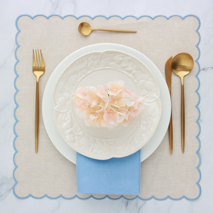 Place setting with Beach scalloped placemat and cool blue dinner napkin
