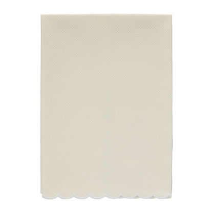 A pale yellow pique fingertip towel with a natural white scalloped edge
