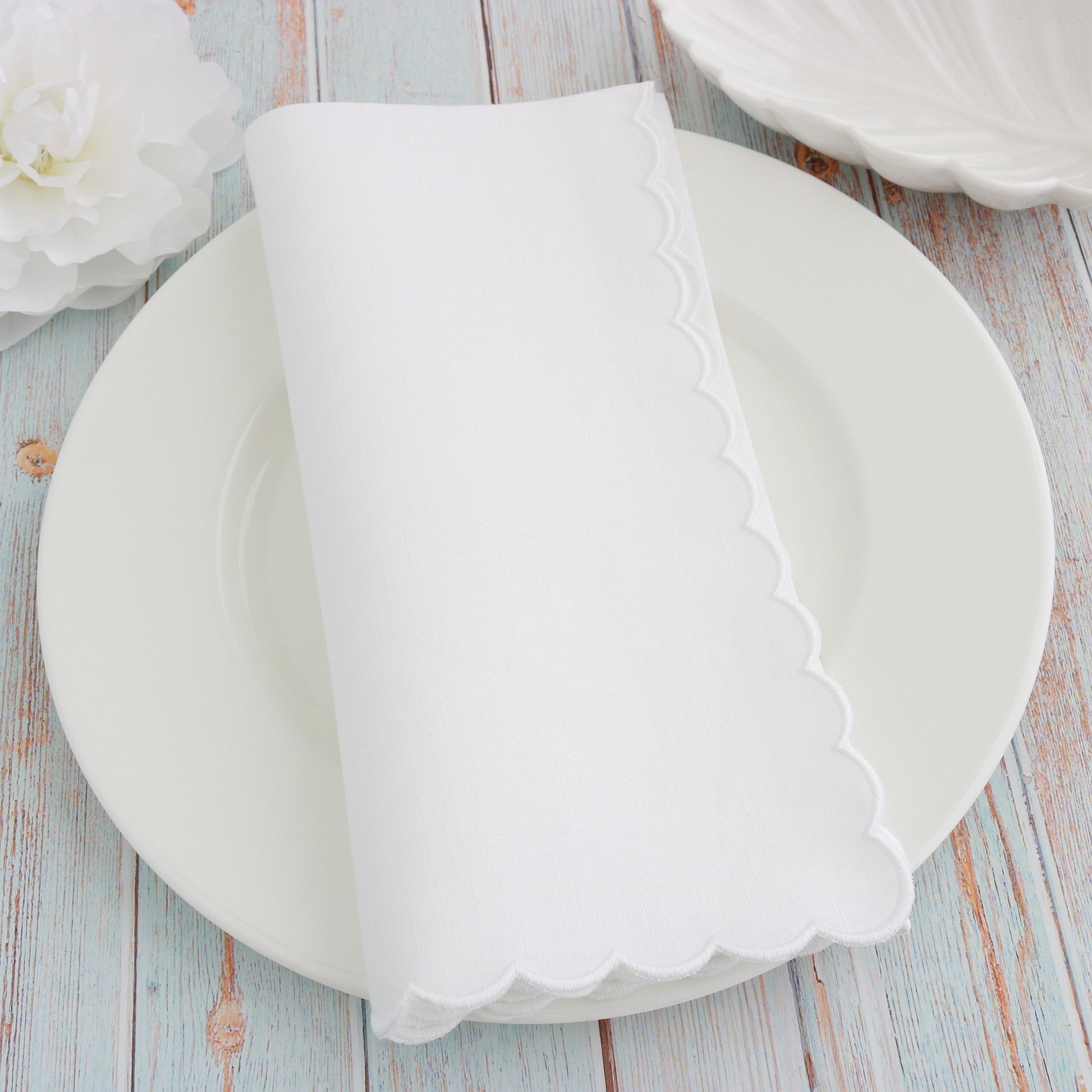 place setting with White scalloped linen napkin and White scallops