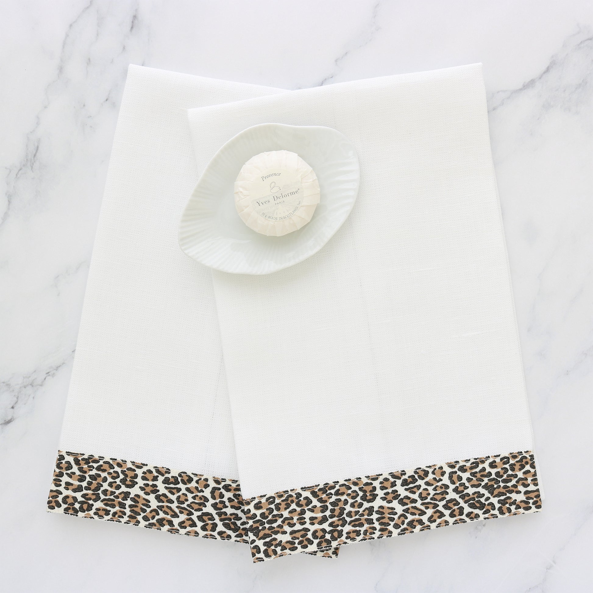 set of two white linen guest towels with cheetah print ribbon trim