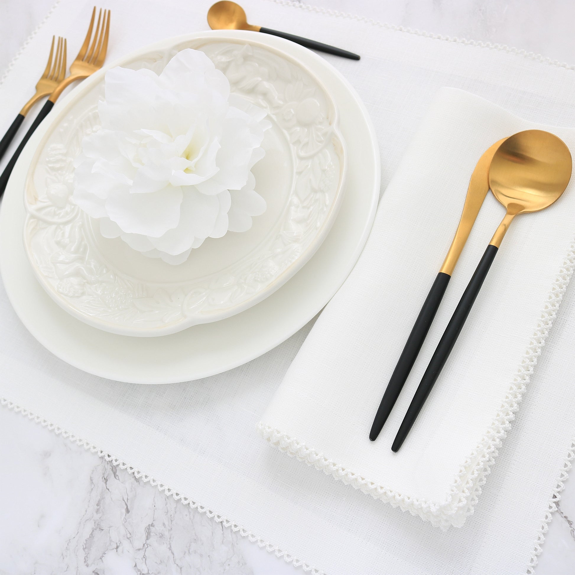 white placemat with white picot trim and matching dinner napkin