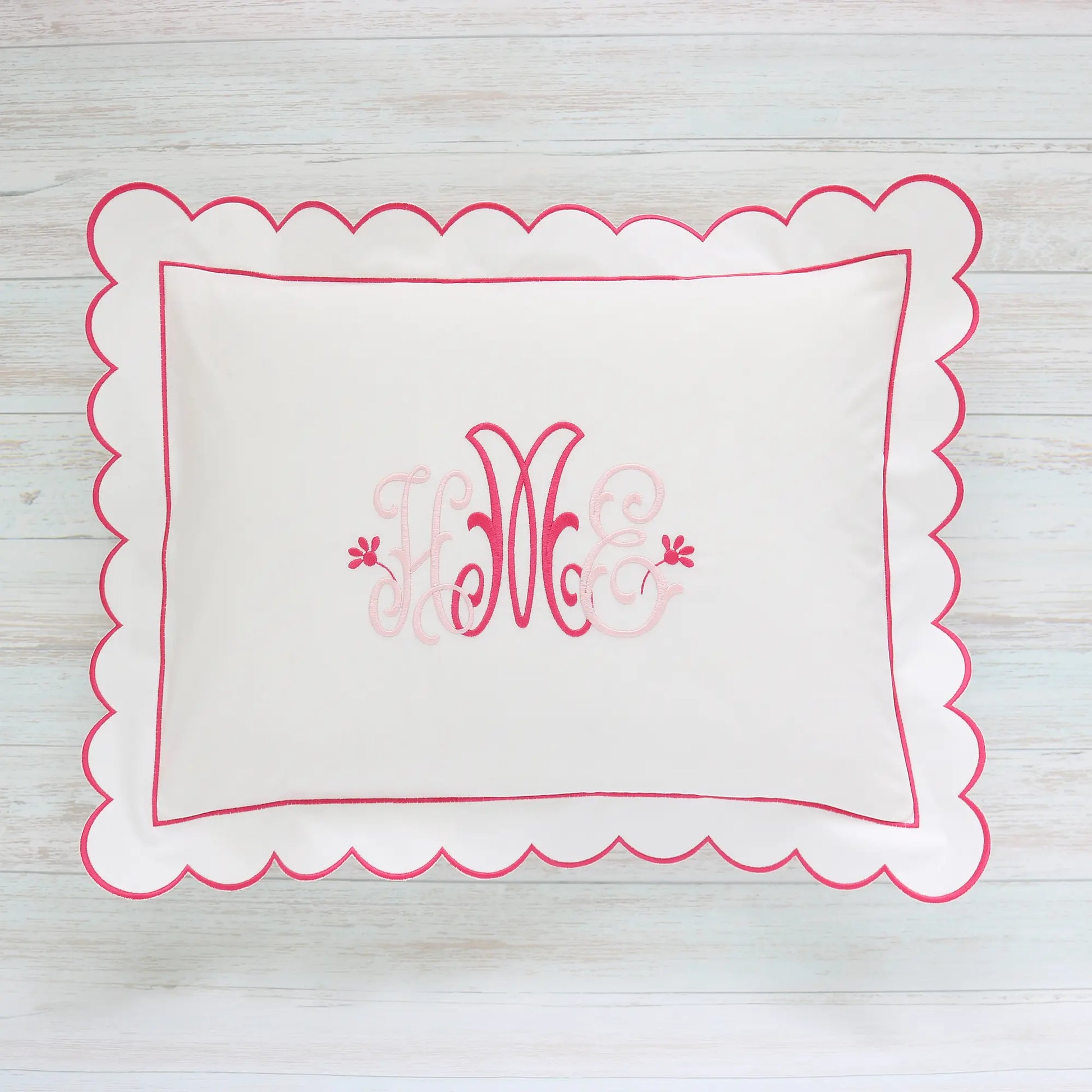 White percale boudoir sham with monogram Camellia in shades of pink