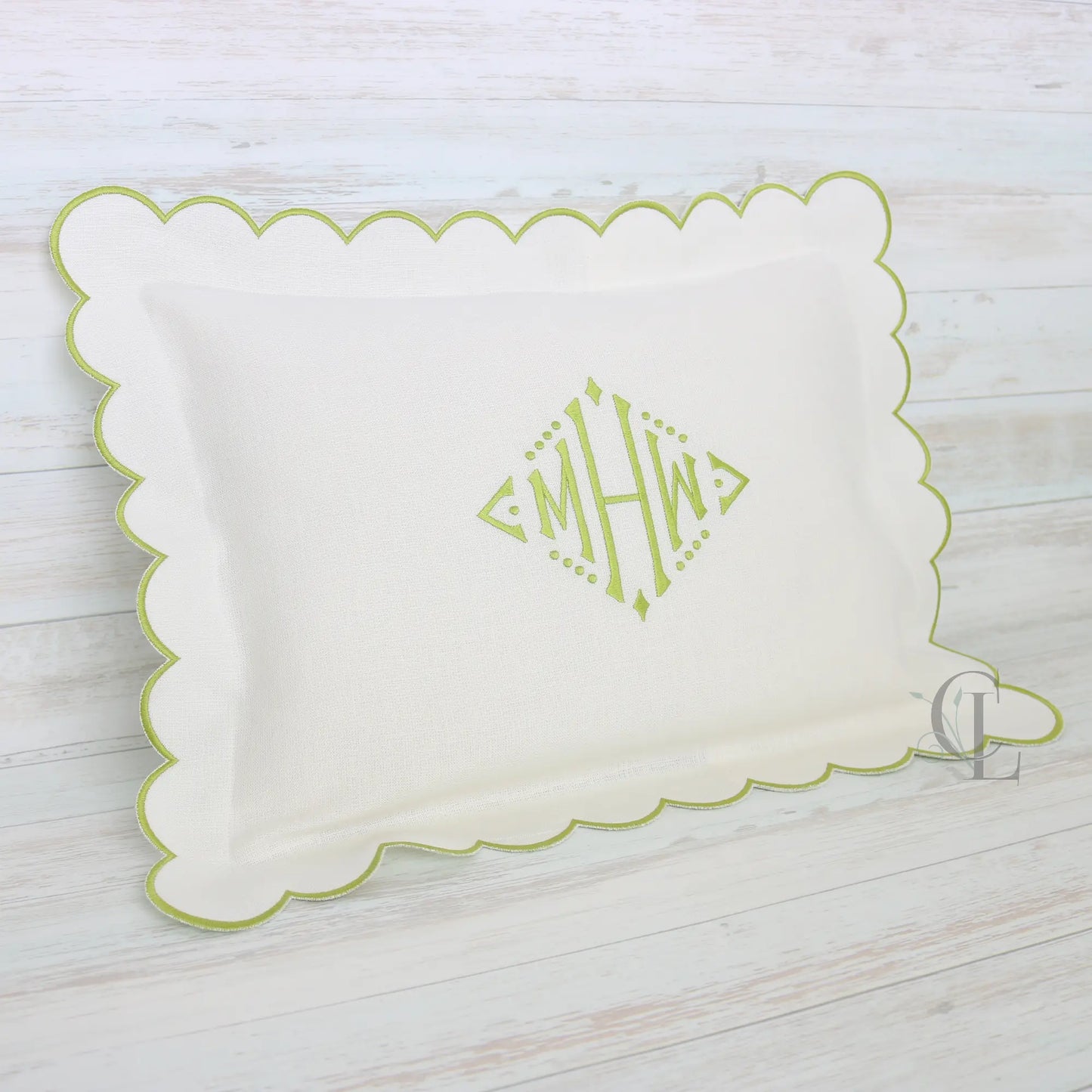 White pillow with green scalloped edge and monogram MHW in sage green handmade by Cora's Linen