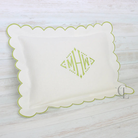 White pillow with green scalloped edge and monogram MHW in sage green handmade by Cora's Linen