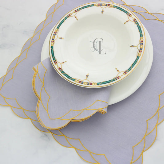 Decorative scalloped Cosmo Lavanda Rosa napkin and placemat with Yellow trim