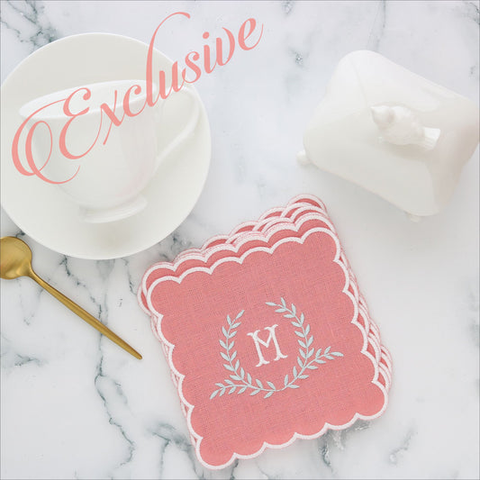 Salmon linen cocktail napkin with white scallops and Napoleon monogram M in White